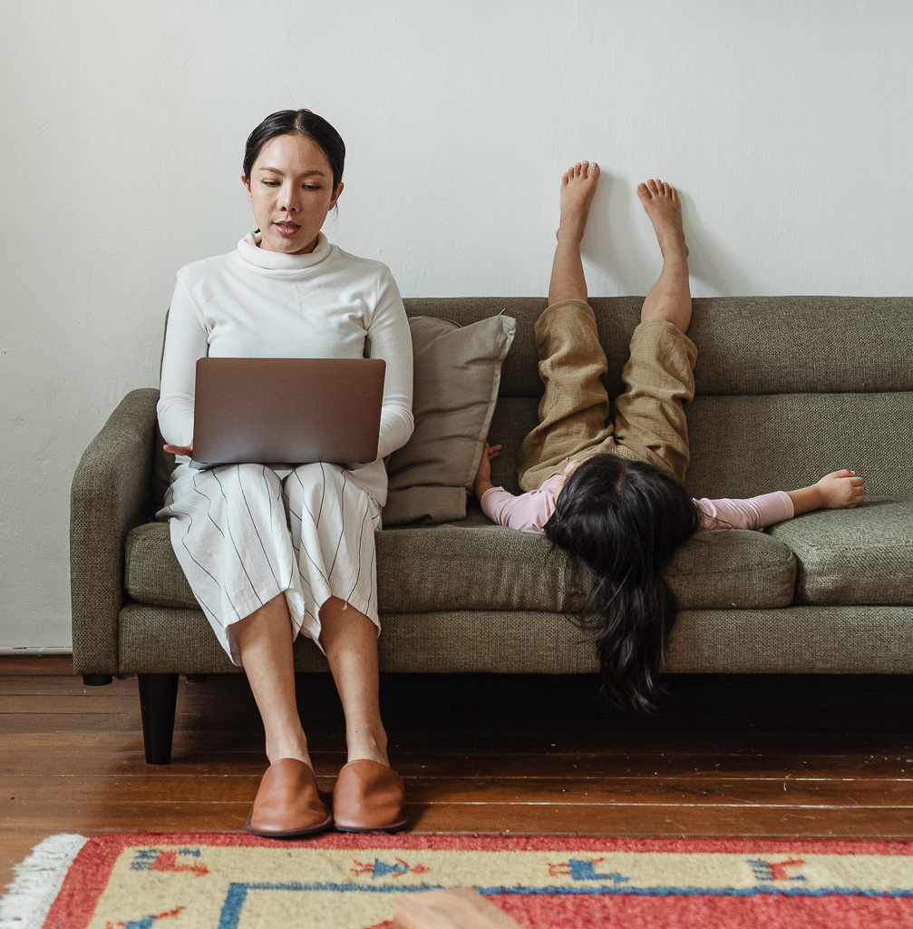mom working with her child on the couch