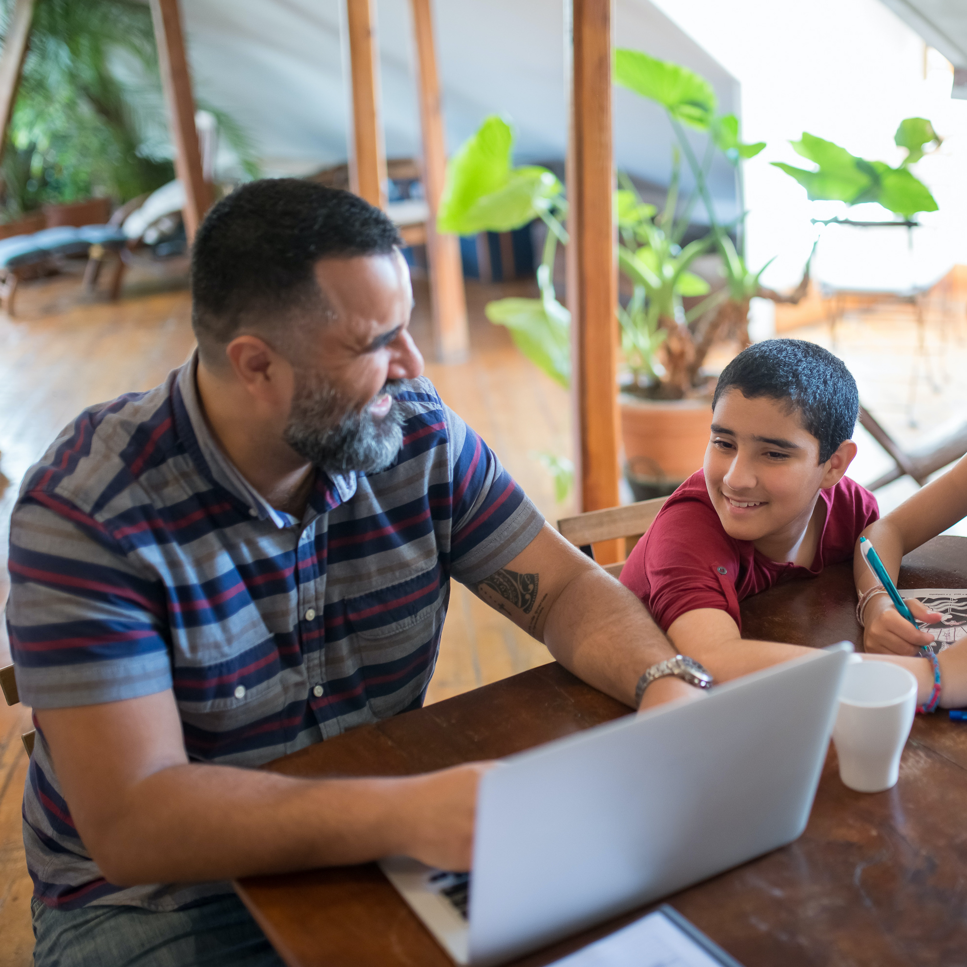 man working from home with his kids