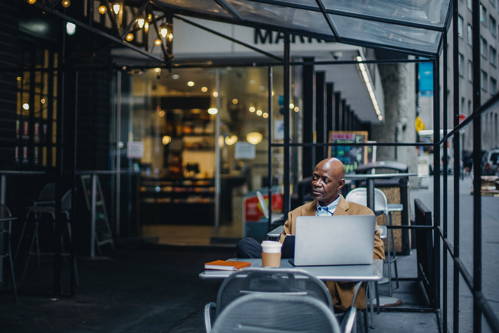 man working from his laptop with coffee